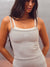 A woman wearing a light gray heathered ribbed camisole tank top with white trim and a matching gray heathered ribbed skirt. The top features the brand name 'SET' printed in white on the chest. <model-info>Jelene wears a size XS and is 5’7”, 23” waist, 32AB bust.</model-info>