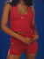 Person wearing a red athletic outfit with 'SET' branding against a blue background