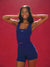 Woman wearing a blue athletic outfit with 'SET' branding against a red background