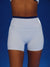 White athletic shorts with a blue waistband on a blue background