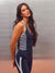 A woman modeling a navy blue athletic one-piece swimsuit with white stripes on the torso and white side accents, paired with matching navy leggings, set against a textured gray wall. <model-info>Jelene wears a size XS and is 5’7”, 23” waist, 32AB bust.</model-info>