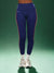Person wearing blue leggings with red stripes on a green background