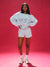 Person wearing a light blue sweatshirt with 'SET' text on a red background