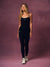A woman modeling a black sleeveless bodysuit with zebra trim on the straps and chest, paired with matching black leggings and white sneakers, set against a textured mauve studio backdrop. <model-info> Andrea wears a size S and is 5’9”, 25½” waist, 32” bust.</model-info>