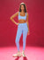 Woman wearing a blue athletic outfit on a red background