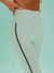Light green leggings with a dark green stripe on a light blue background