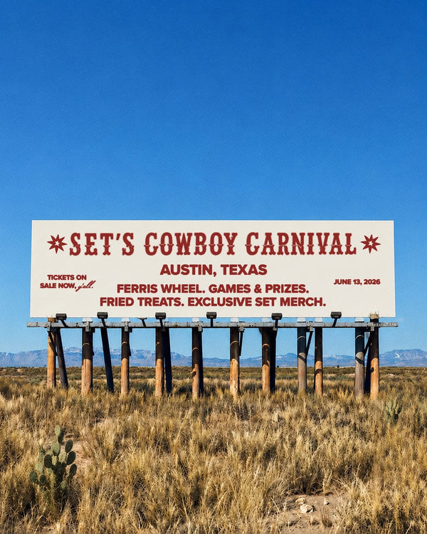 Sign in the middle of the field with writing on a billboard.