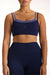 Navy blue sports bra and leggings set on a model against a white background