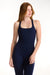 Woman wearing a navy blue tank top and leggings on a white background <model-info>Dickey wears a size S and is 5’9”, 24” waist, 32” bust.</model-info>