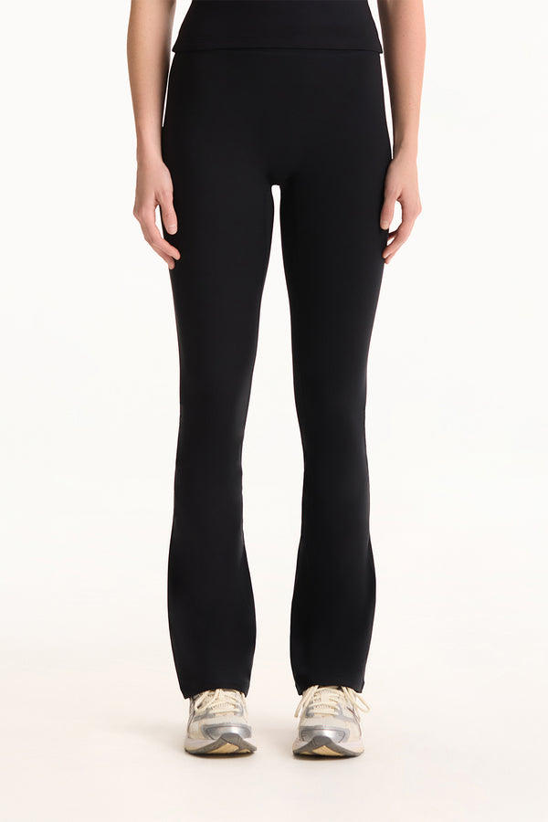 Person wearing black leggings on a white background 