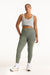 Woman wearing a gray tank top and green leggings on a white background