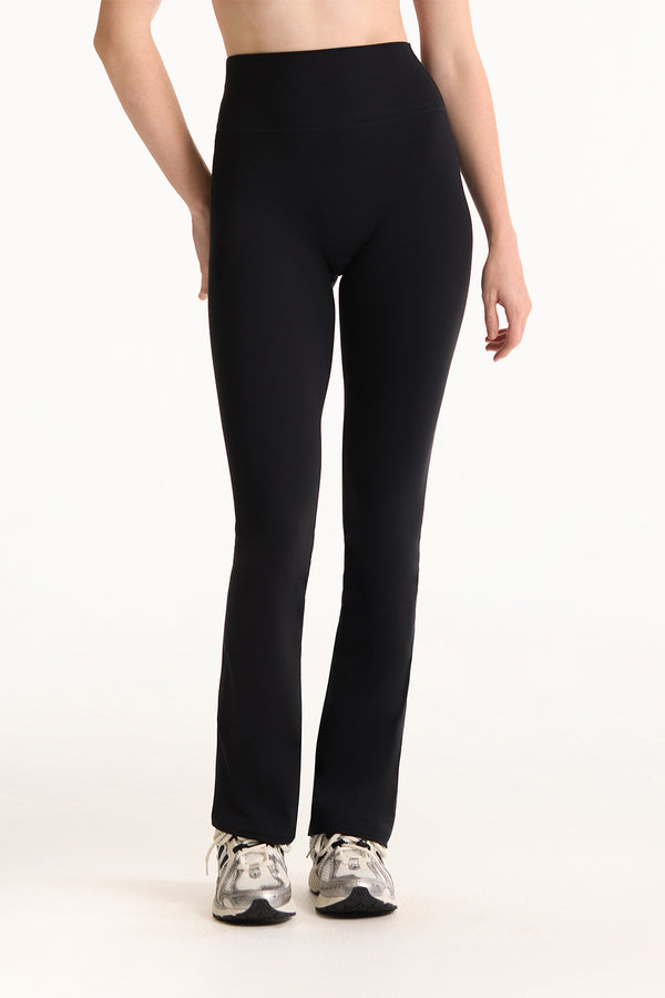 Person wearing black leggings on a white background 