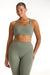 Woman wearing a green sports bra and leggings set on a white background <model-info>Jade wears a size L and is 5’9”, 30” waist, 38” bust.</model-info>