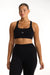 Woman wearing a black sports bra and leggings with 'SET' branding on a white background <model-info>Jade wears a size L and is 5’9”, 30” waist, 38” bust.</model-info>