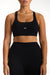 Black sports bra with 'SET' logo worn by a person on a white background