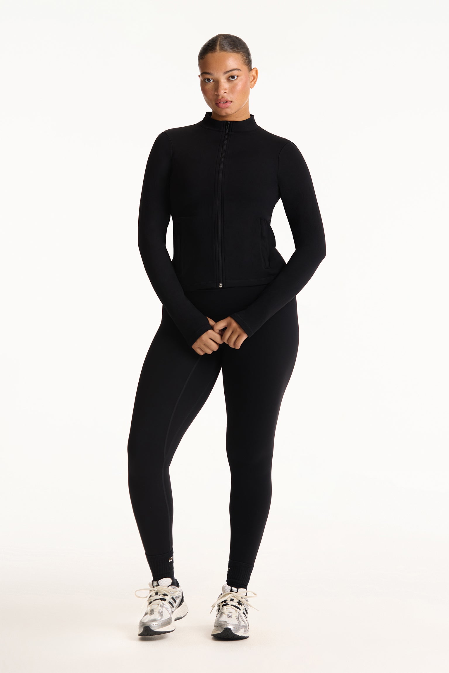 Person wearing a black athletic outfit on a white background