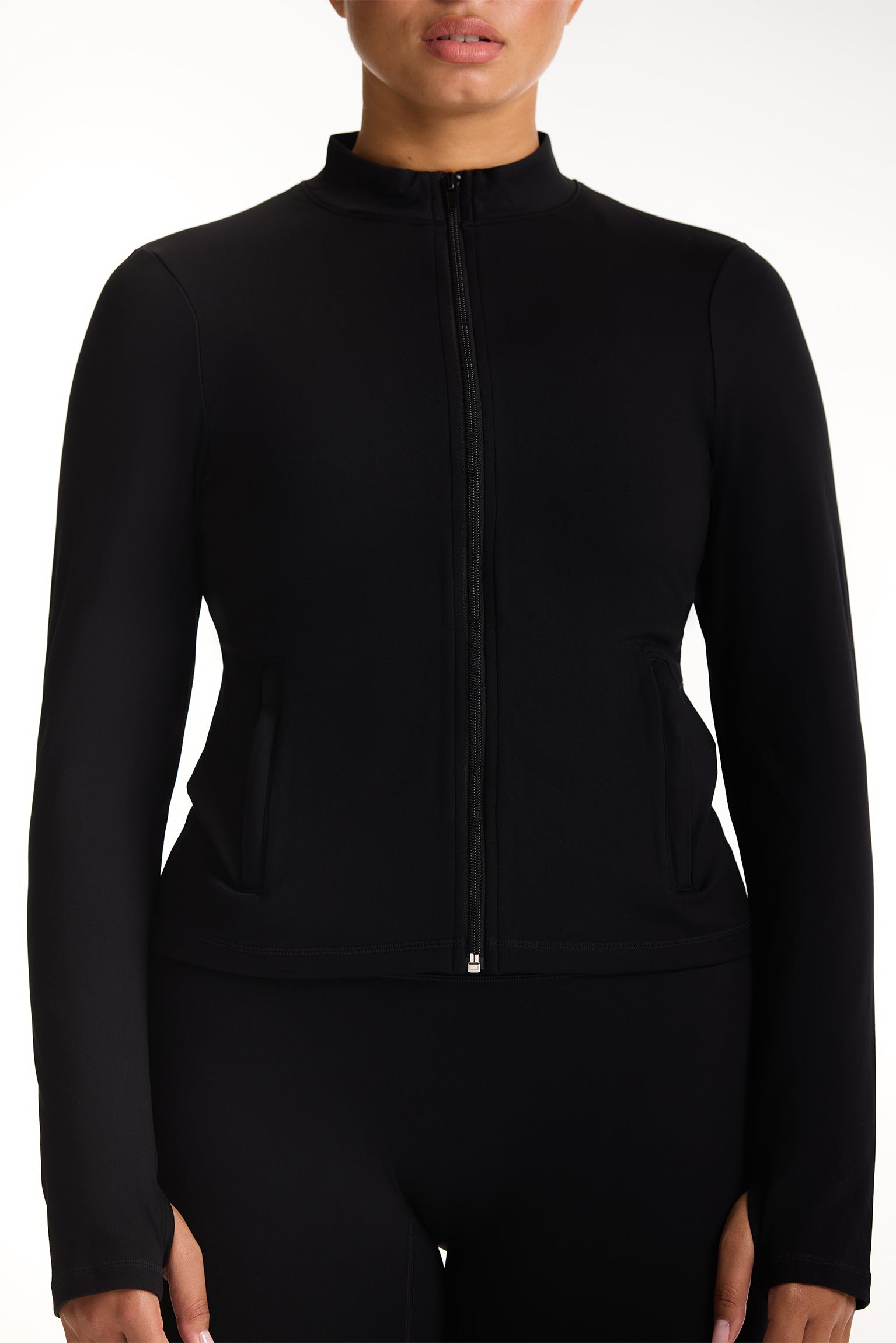 Black zip-up jacket worn by a person on a white background