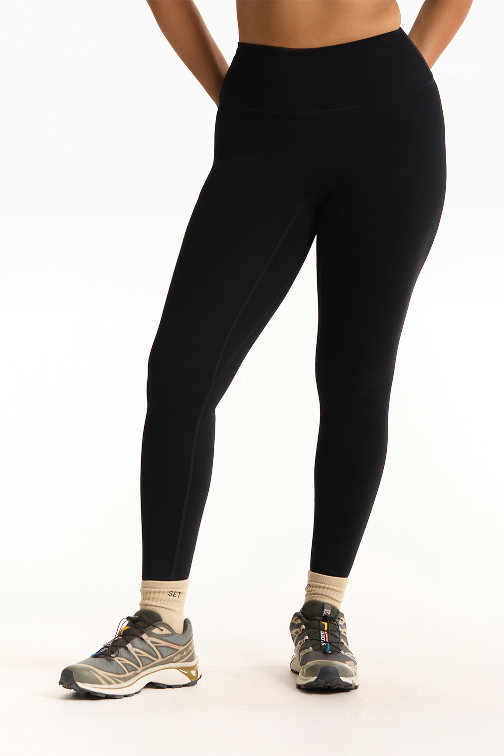 Person wearing black leggings on a white background <model-info>Jade wears a size L and is 5’9”, 30” waist, 38” bust.</model-info>