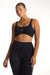 Woman wearing a black sports bra and leggings with 'SET' branding on a white background <model-info>Jade wears a size L and is 5’9”, 30” waist, 38” bust.</model-info>