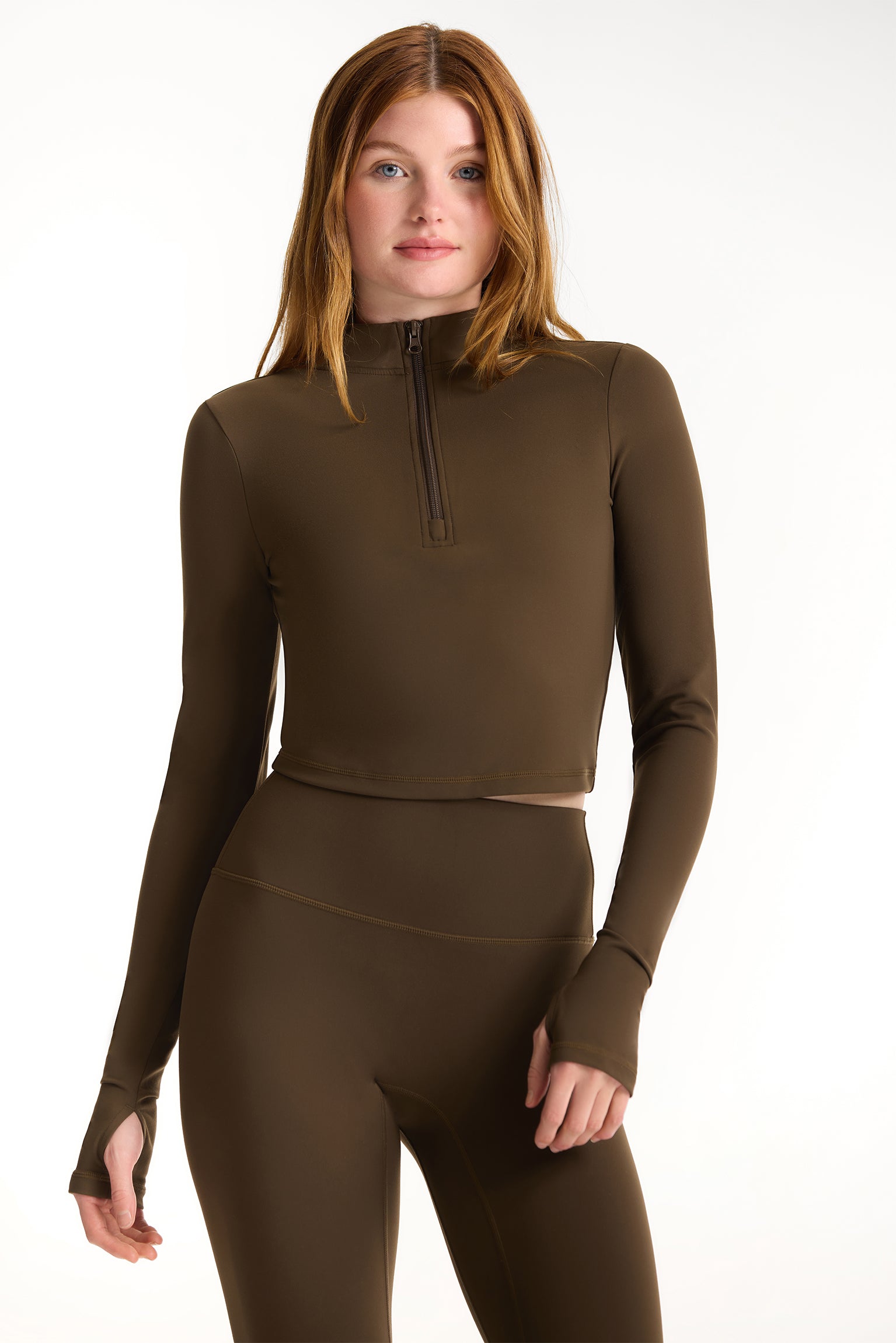 Woman wearing a brown long-sleeve top and leggings on a white background <model-info>Dickey wears a size S and is 5’9”, 24” waist, 32” bust.</model-info>