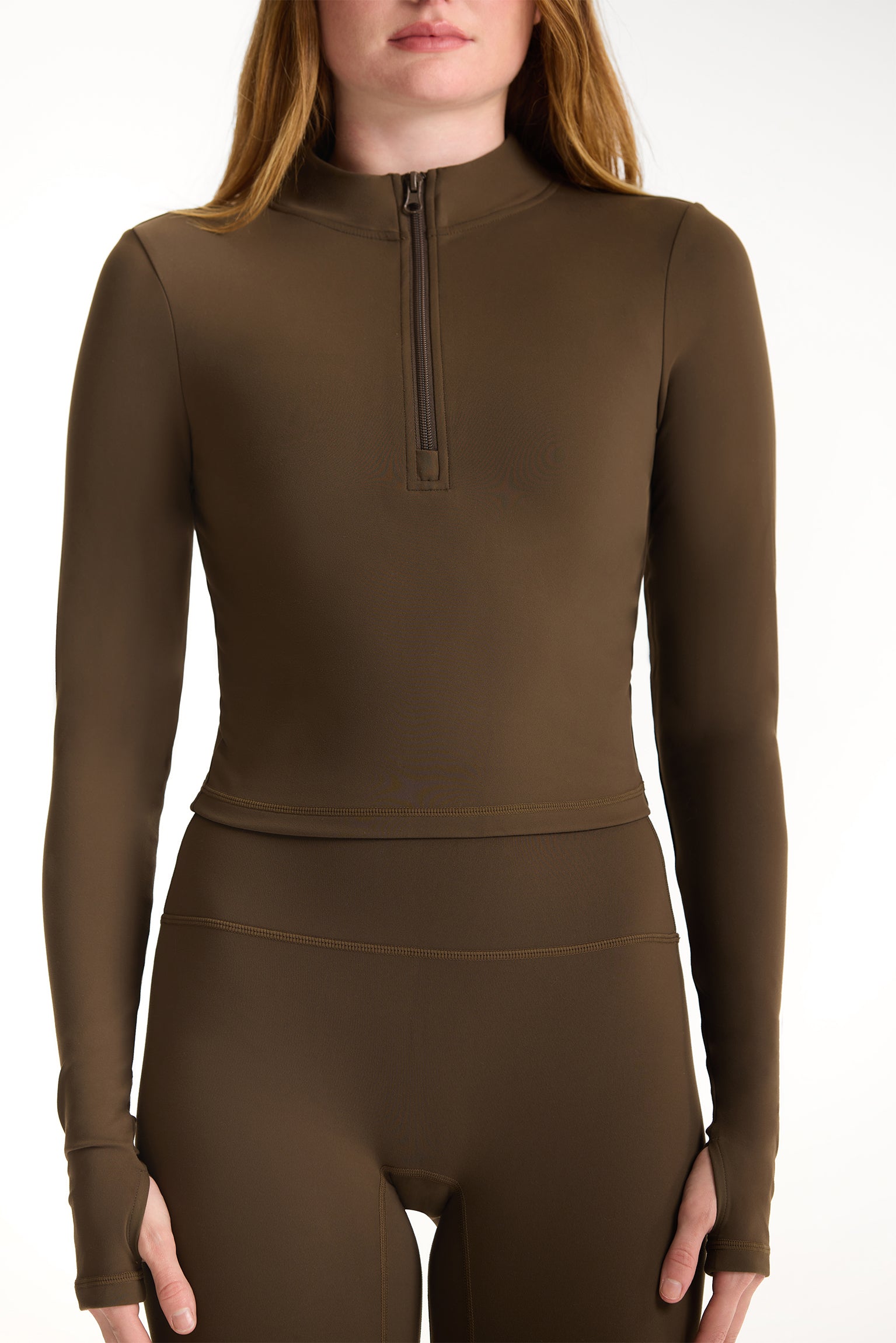 Brown long-sleeve top with a quarter zip on a white background