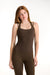 Woman wearing a brown tank top and leggings on a white background <model-info>Dickey wears a size S and is 5’9”, 24” waist, 32” bust.</model-info>