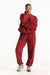 Person wearing a red tracksuit on a white background