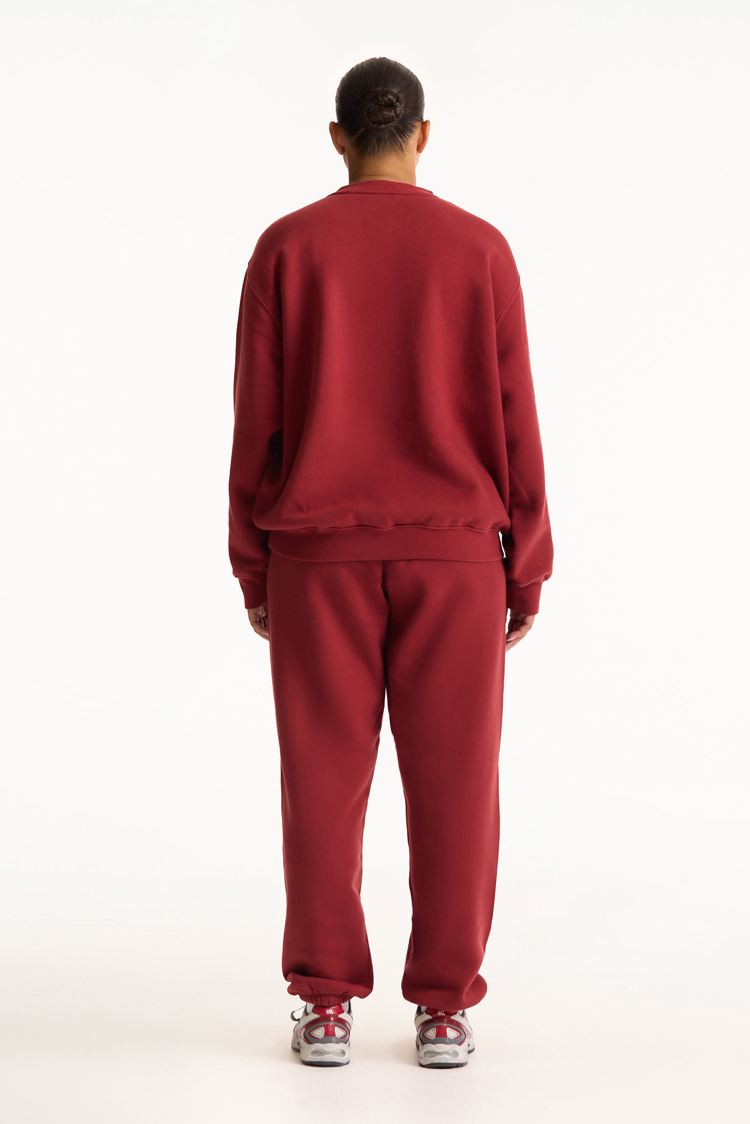 Person wearing a red tracksuit on a white background