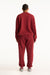 Person wearing a red tracksuit on a white background