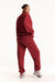 Person wearing a red tracksuit on a white background