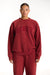 Person wearing a red 'SET' sweatshirt on a white background <model-info>Jade wears a size L and is 5’9”, 30” waist, 38” bust.</model-info>