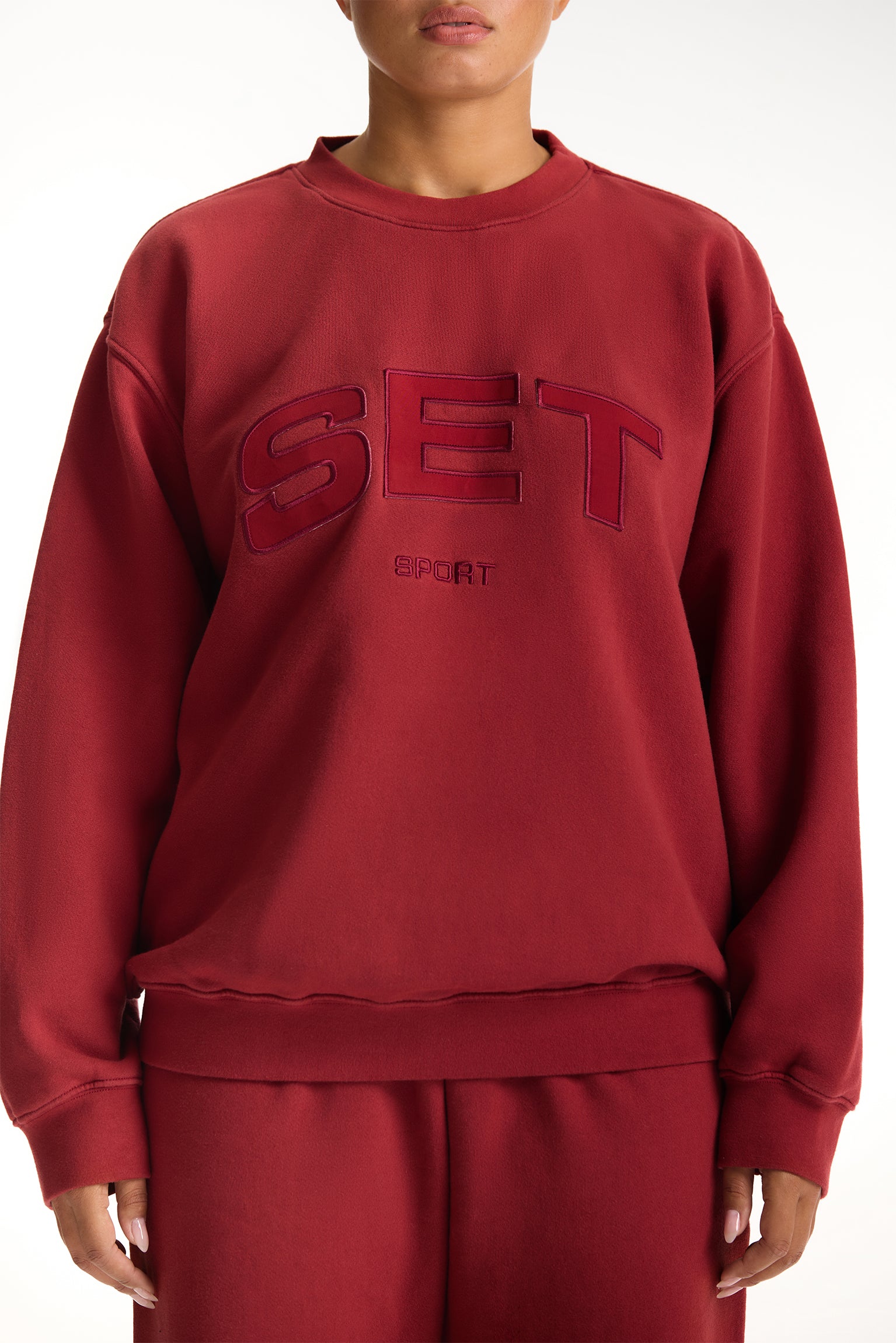 Red sweatshirt with 'SET' logo on a white background