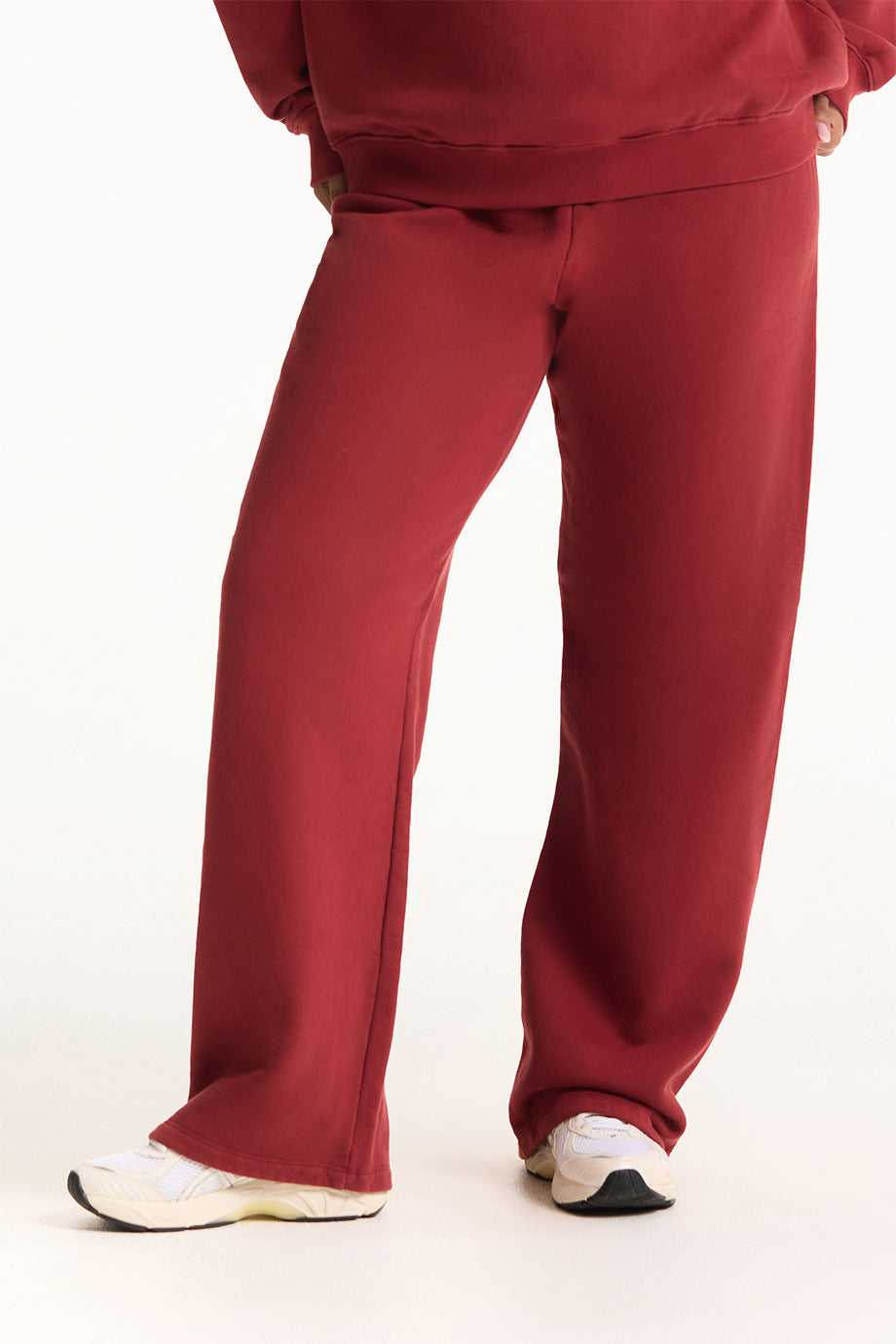 Red pants worn by a person on a white background <model-info>Jade wears a size L and is 5’9”, 30” waist, 38” bust.</model-info>