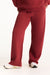 Red pants worn by a person on a white background <model-info>Jade wears a size L and is 5’9”, 30” waist, 38” bust.</model-info>