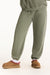 Person wearing olive green sweatpants and brown slippers on a white background <model-info>Jade wears a size L and is 5’9”, 30” waist, 38” bust.</model-info>