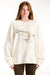 Woman wearing a cream-colored sweatshirt with a fish graphic and text on a white background <model-info>Dickey wears a size L and is 5’9”, 24” waist, 32” bust.</model-info>