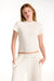 Woman wearing a white crop top and pants on a white background <model-info>Dickey wears a size S and is 5’9”, 24” waist, 32” bust.</model-info>