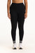 Person wearing black leggings with white sneakers on a white background