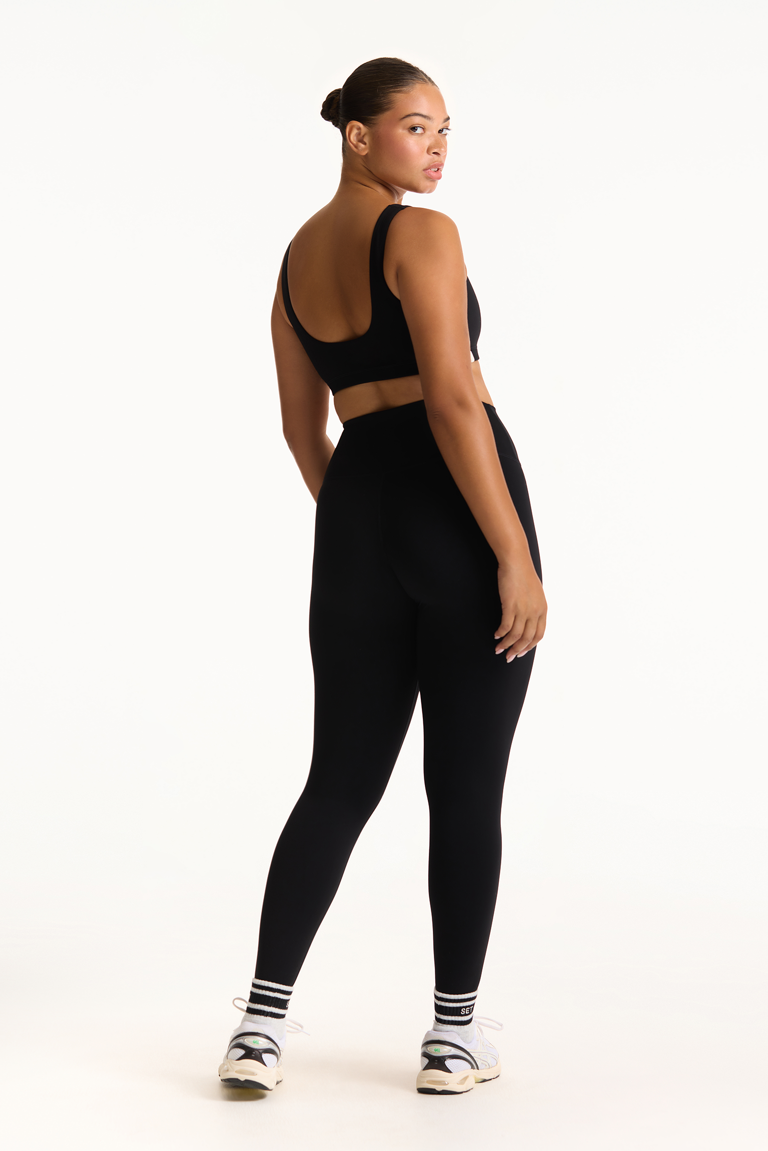 Person wearing a black athletic outfit on a white background