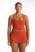 Woman wearing an orange dress on a white background
