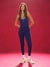 Woman wearing a blue athletic outfit on a red background