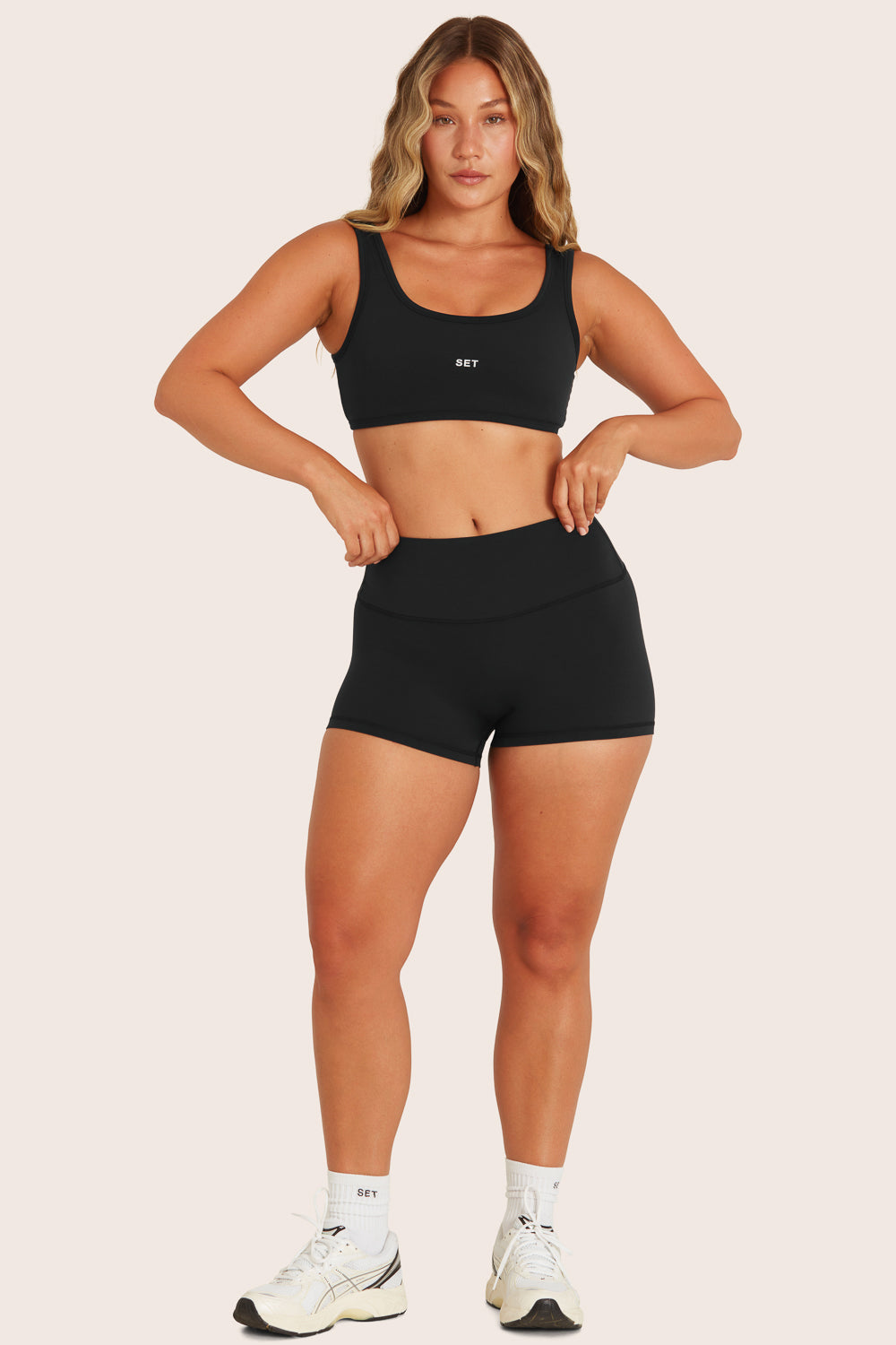 MODEL WEARS BREATHE MINI SHORTS IN ONYX 