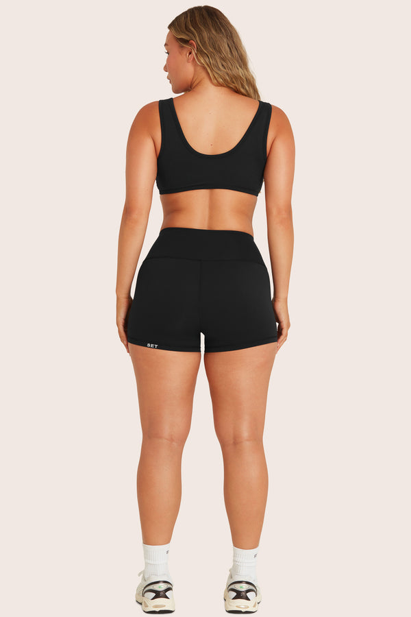 MODEL WEARS BREATHE MINI SHORTS IN ONYX 