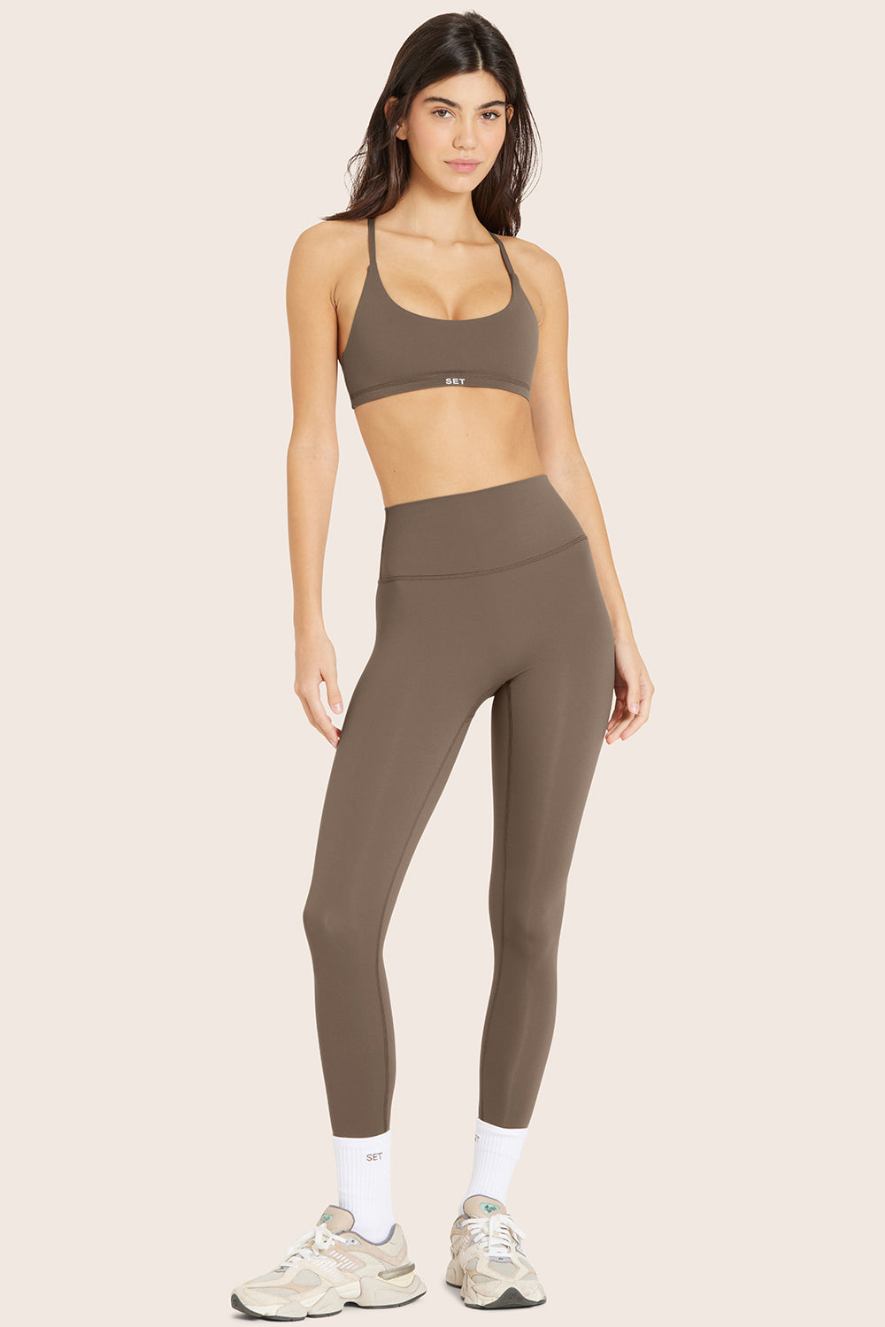 MODEL WEARS BREATHE LEGGINGS IN TRUFFLE 