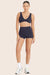 MODEL WEARS BREATHE MINI SHORTS IN SPADES 