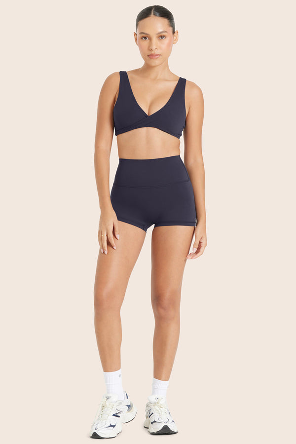 MODEL WEARS BREATHE MINI SHORTS IN SPADES 