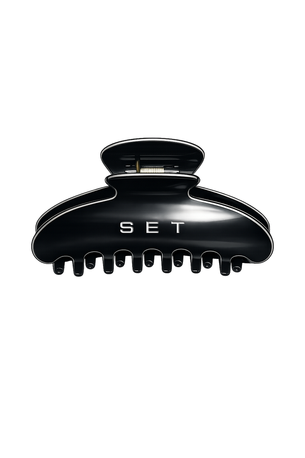A glossy black hair claw clip with the brand name 'SET' printed in white on the front, shown against a plain white background.
