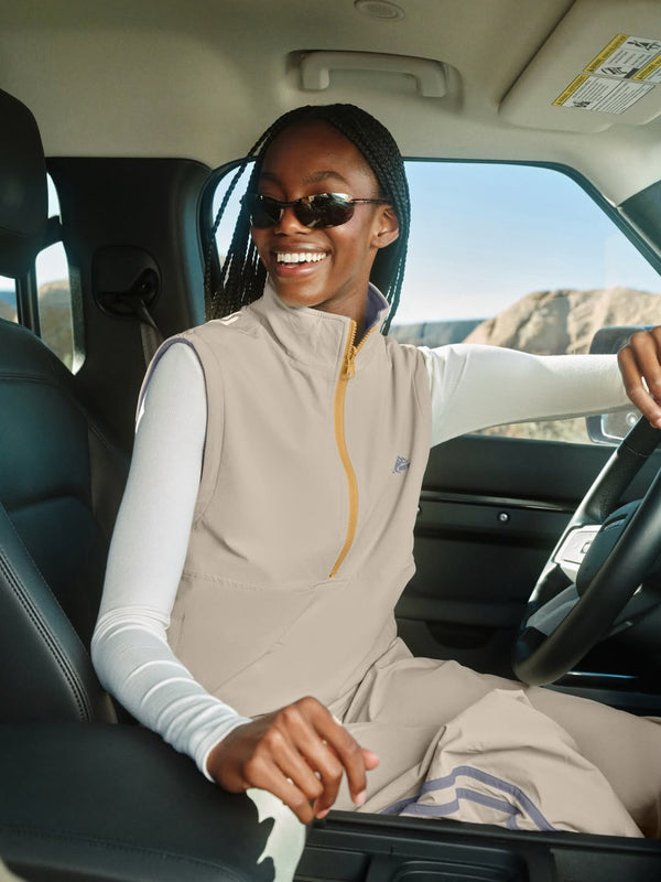 Woman wears tan activewear set in car