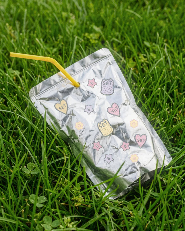 Clear plastic bag with cartoon character designs on grass