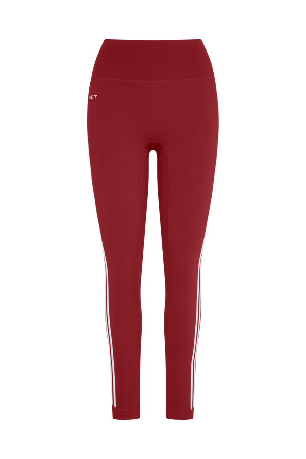 Red leggings with a white stripe on a white background